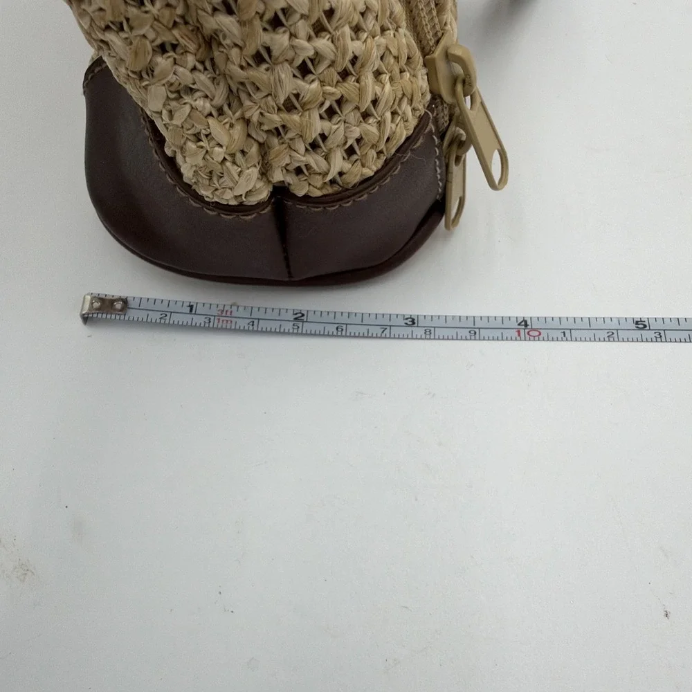Rosetti straw tote handbag with brown faux leather trim‎ and top handles.